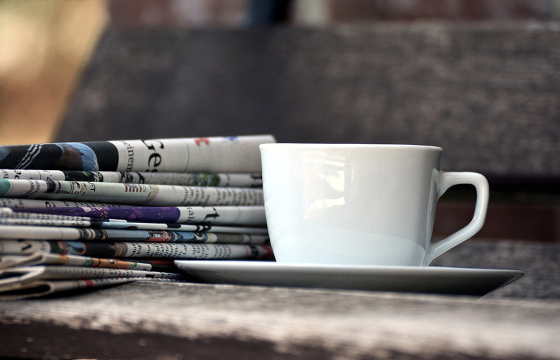 newspaper and coffee cup